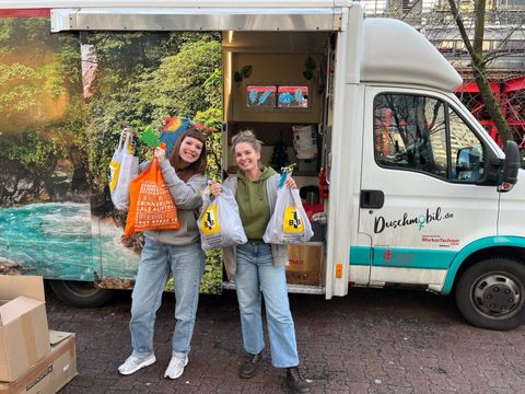 Duschmobil-Team mit Spenden des BAB-Teams in Taschen