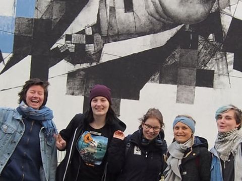 Eine Gruppe Jugendliche vor Graffitikunst in Brüssel