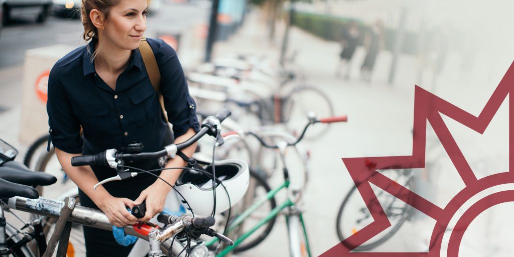 Junge Frau im blauen Hemd schließt ihr Fahrrad an