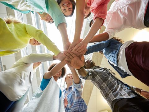 group of international students with hands on top