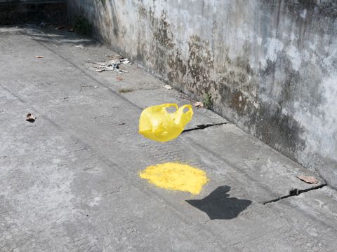 Bildvergrößerung: Fotografie einer fliegenden gelben Kunststofftüte