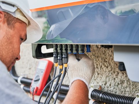 Elektriker beim Anschließen einer PV-Anlage