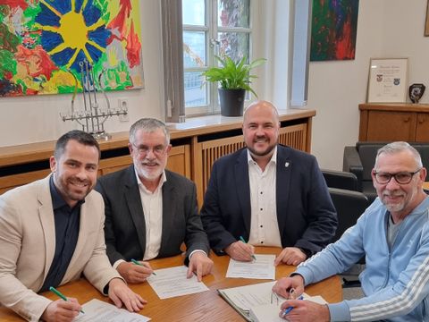 Bildvergrößerung: Altstadtmanagement Vertrag Verlängerung - The und Andreas Wunderlich sitzen gemeinsam mit Frank bewig und Ricky Jahn am Tisch und unterschreiben den Vertrag