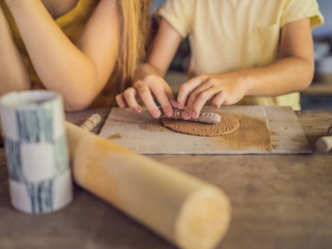 mother and son doing ceramic pot in pottery workshop