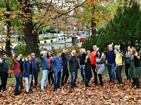 Viele Menschen vor Herbstbäumen