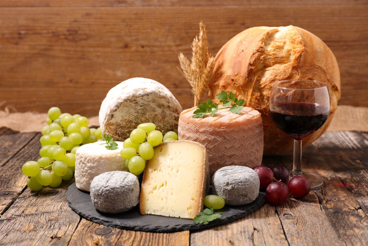 assorted cheese and wine glass