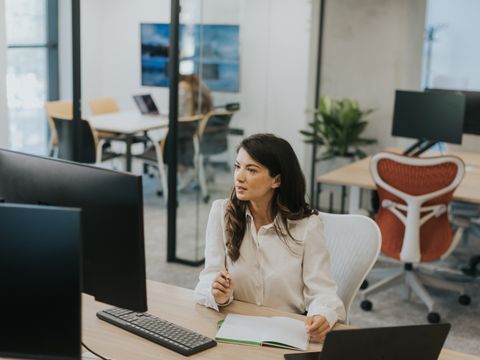 Young business woman working on laptop in the modern office