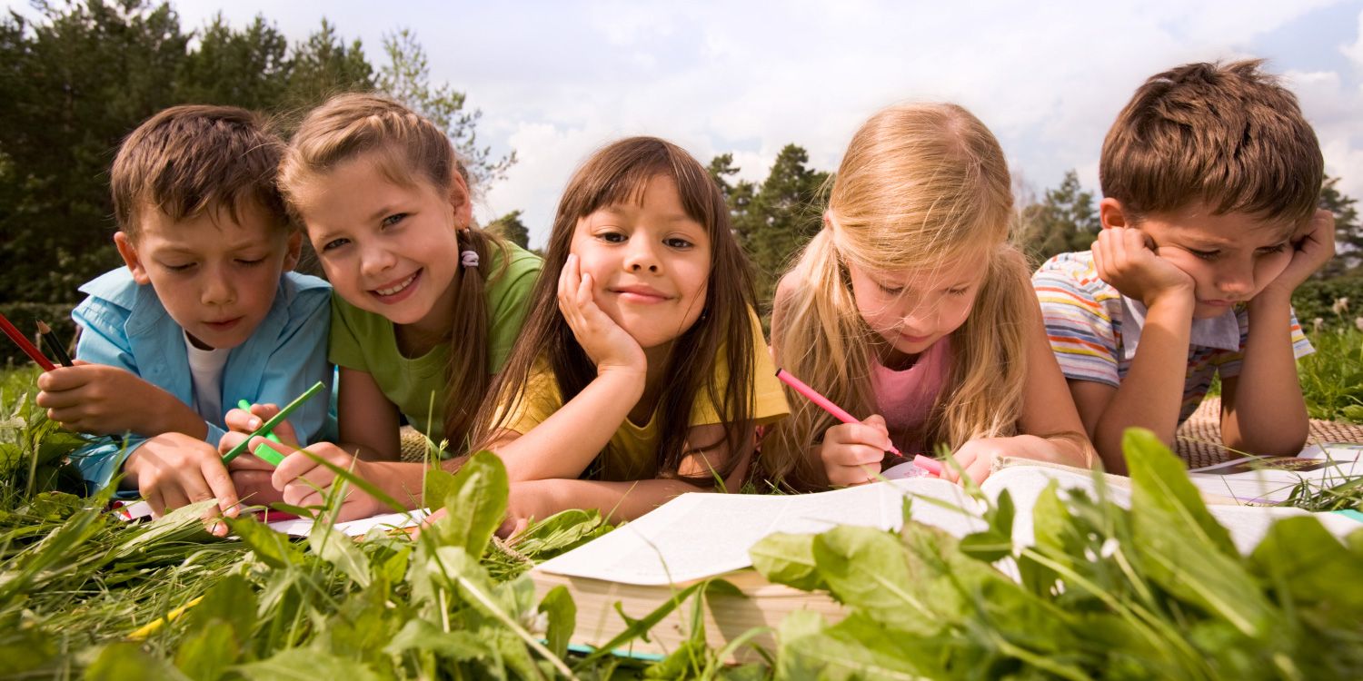 Schulkinder auf einer Wiese