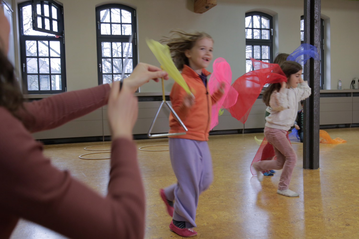 Kinder tanzen mit Tüchern nach Triangeltakt